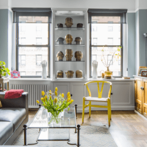 Interior of a New York City apartment decorated with eclectic furniture and antique vases