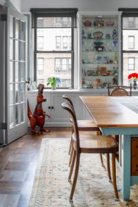 looking through a dining room out the window of an apartment