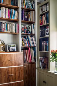 bookshelves overflowing with books and family photos