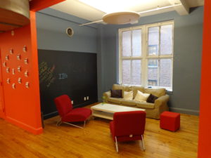 brightly painted orange and green nyc living room