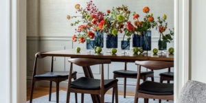 decorative fruits and flowers on a table in a dining room