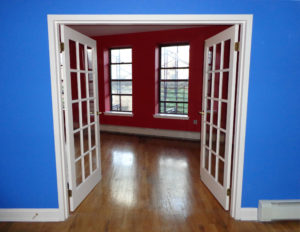 bright blue room with white French doors