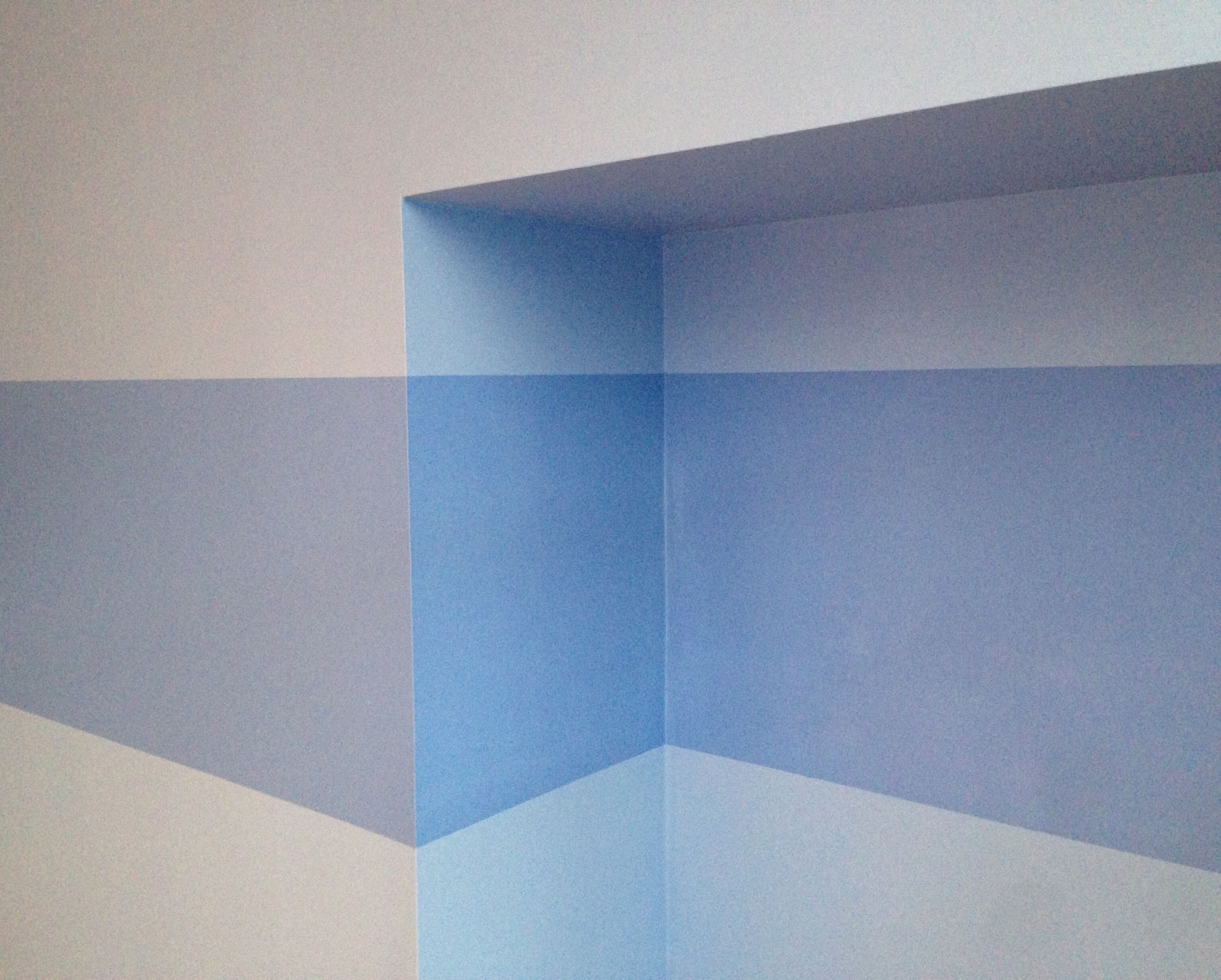 Bright blue stripe painted along a dull blue wall