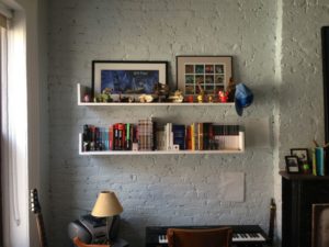 shelves with tchotchkes on a white brick wall