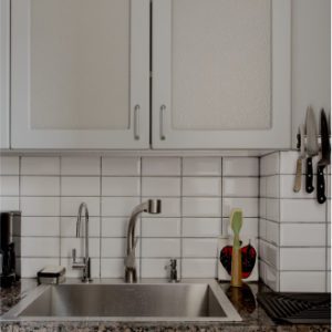 white tiled apartment kitchen