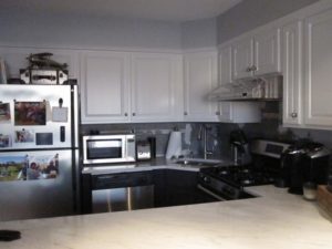 Another view of white repainted cabinets in a kitchen