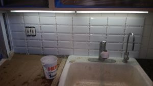 freshly tiled backsplash with white subway tile