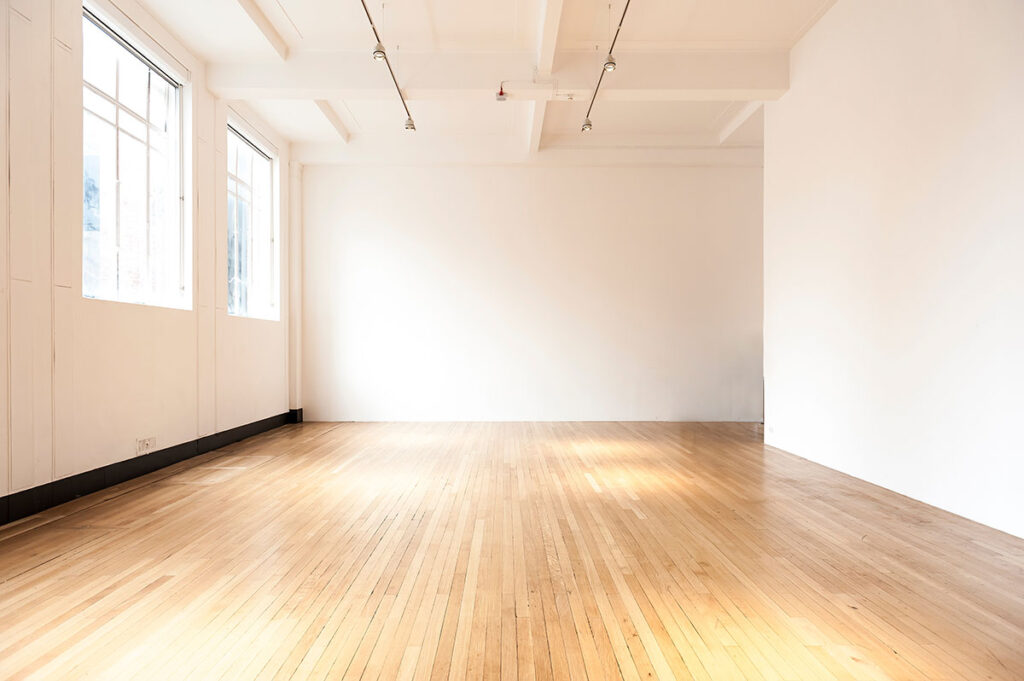Interior of an apartment freshly painted with urethaned floors ready for sale