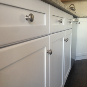 White paint sprayed kitchen cabinets refinished