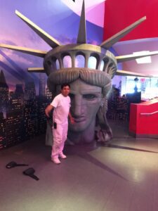 painter posing with a Statue of Liberty head replica