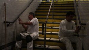 workers painting a staircase in an office building