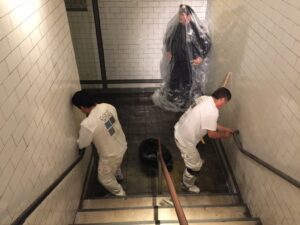 workers painting a stairwell