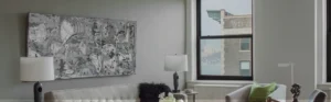 Looking out a window with partial views of the Hudson River in a modern, elegant apartment living room