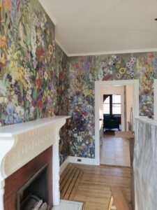 floral wallpaper over a fireplace