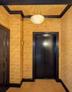 hallway with yellow patterned wallpaper